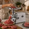 "Masina de tocat carne electrica cu 3 site si putere 2800W KESNUP, multifunctionala, functie de inversare rotatie, control al texturii carnii, site: 3 mm, 5 mm 7 mm, include accesorii pentru umplerea carnatilor, dimensiuni 34 x 33.5 x 9 cm, Alb / Argintiu" 9 "Masina de tocat carne electrica cu 3 site si putere 2800W KESNUP, multifunctionala, functie de inversare rotatie, control al texturii carnii, site: 3 mm, 5 mm 7 mm, include accesorii pentru umplerea carnatilor, dimensiuni 34 x 33.5 x 9 cm, Alb / Argintiu"